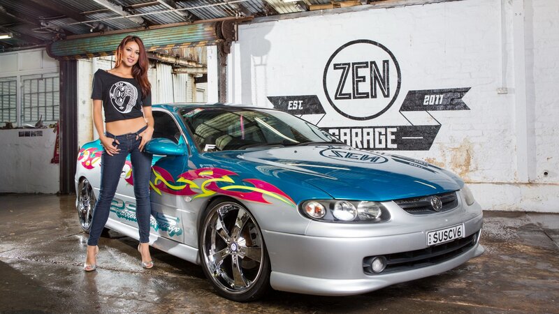 woman with custom car in garage