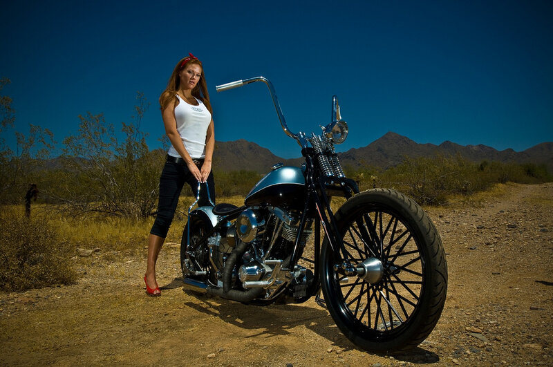 Woman with custom motorcycle in desert