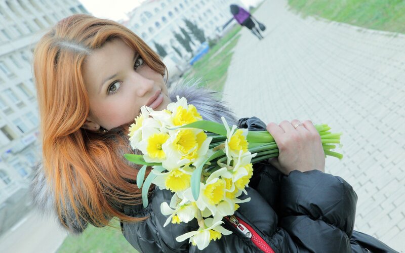 Woman with daffodils in city