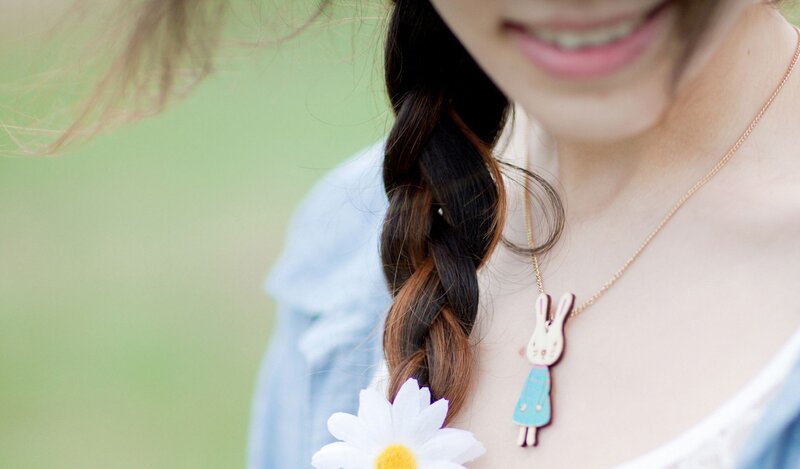 woman with daisy and bunny necklace