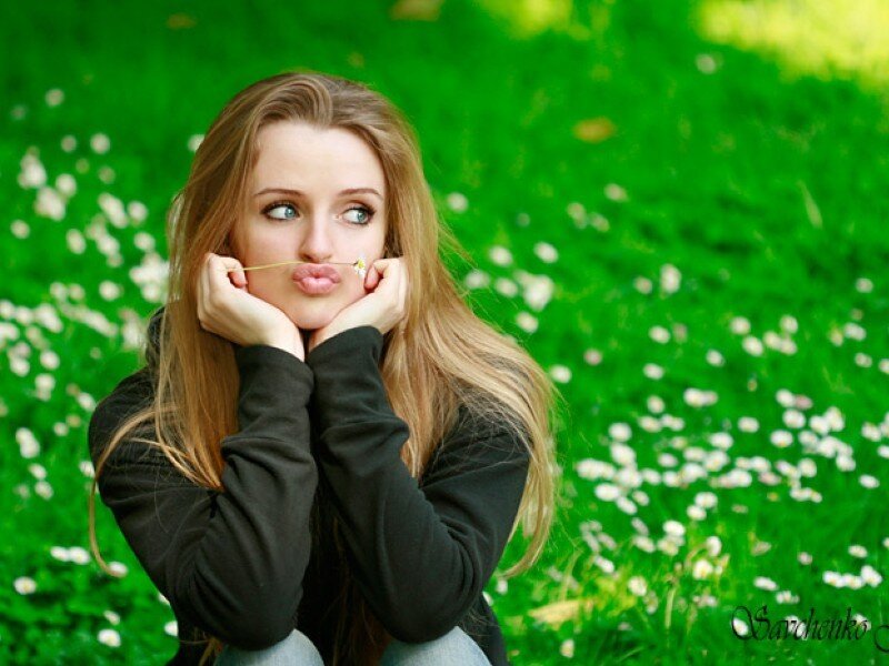 woman with daisy in field