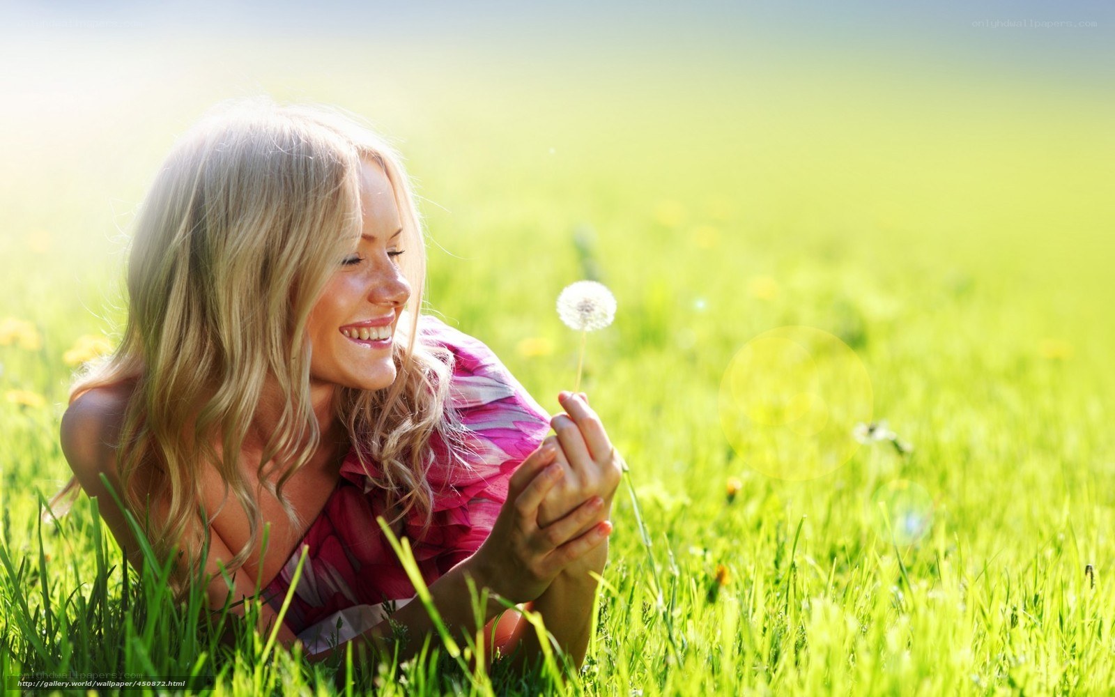 Woman with dandelion in field
