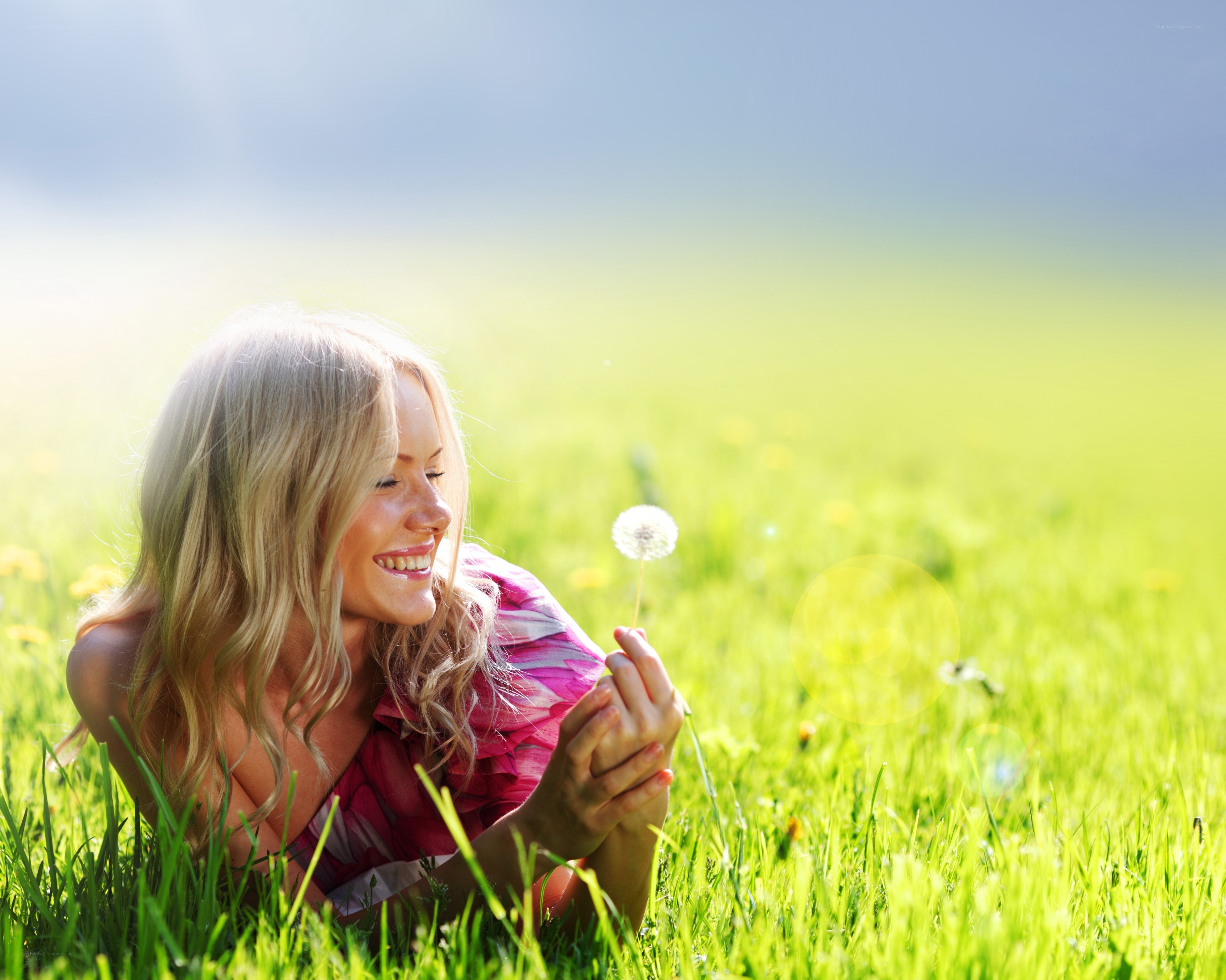 Woman with dandelion in field