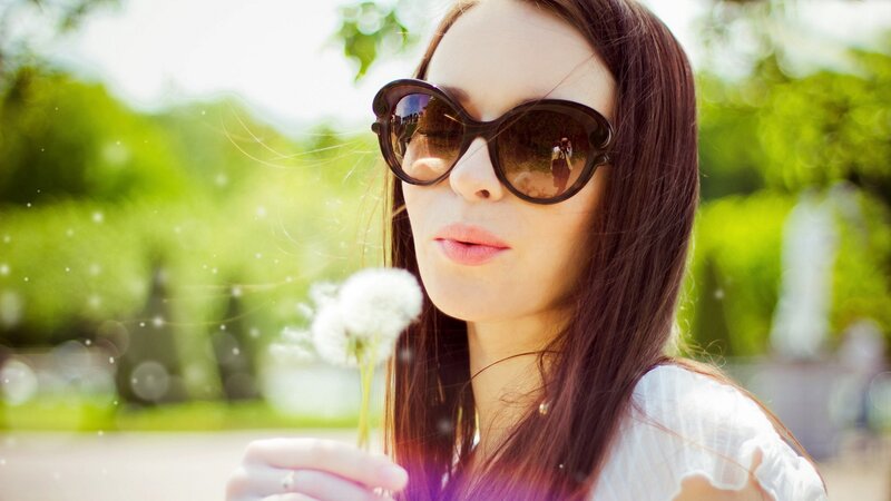 woman with dandelion in park