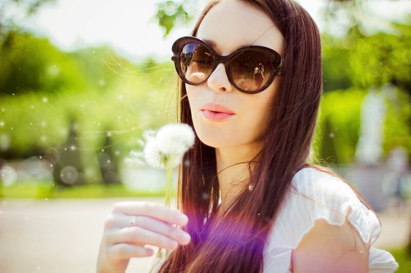 woman with dandelion in park