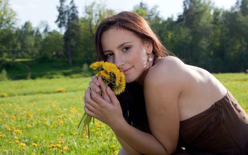 Woman with dandelions in field