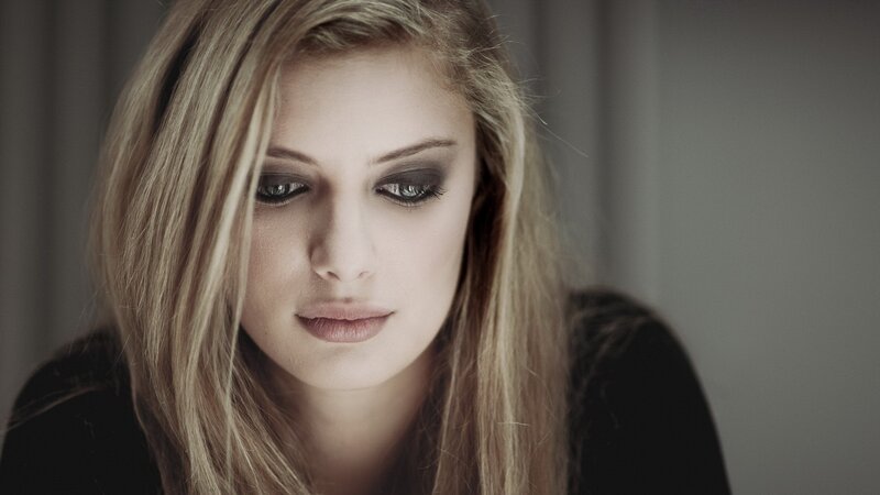 Woman with Dark Eye Makeup — Gray, Somber
