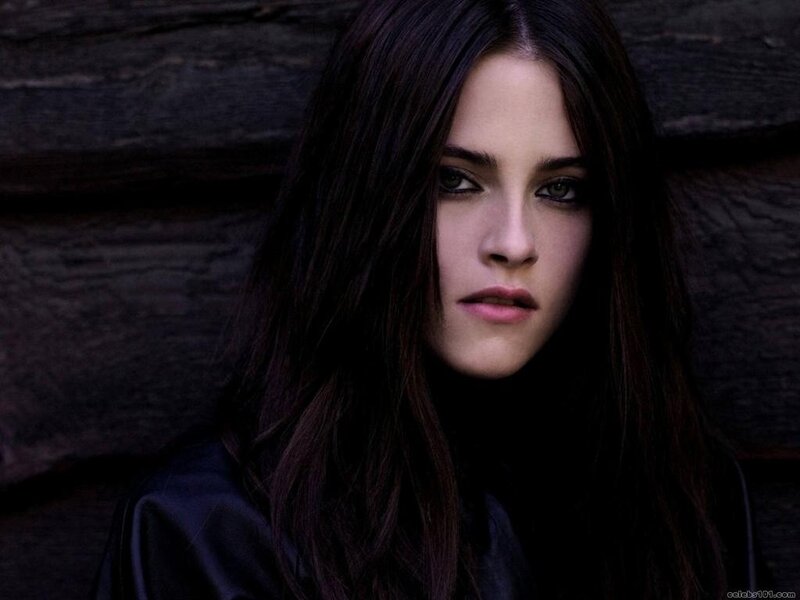 woman with dark hair against wood