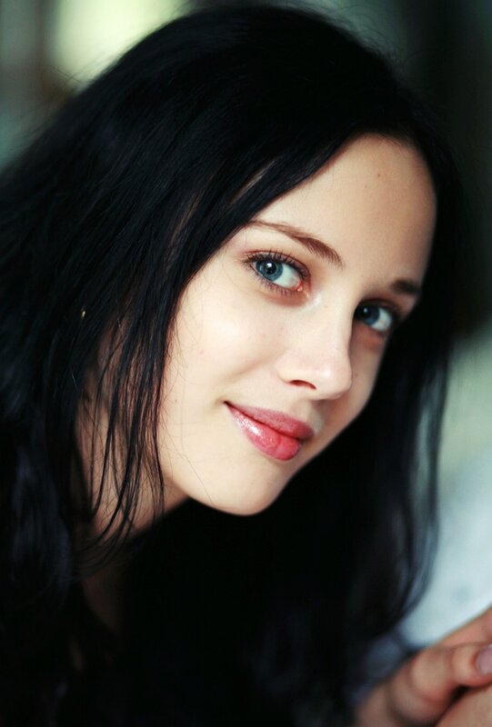 woman with dark hair and blue eyes