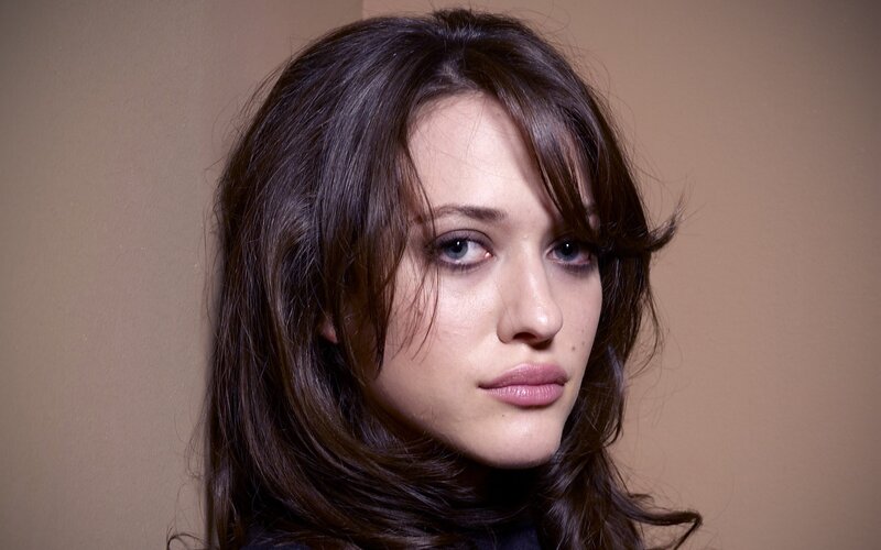 woman with dark hair and blue eyes