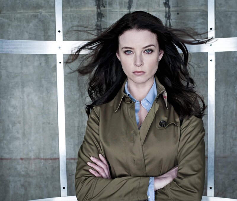 woman with dark hair and blue eyes