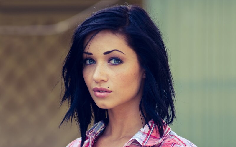 woman with dark hair and blue eyes
