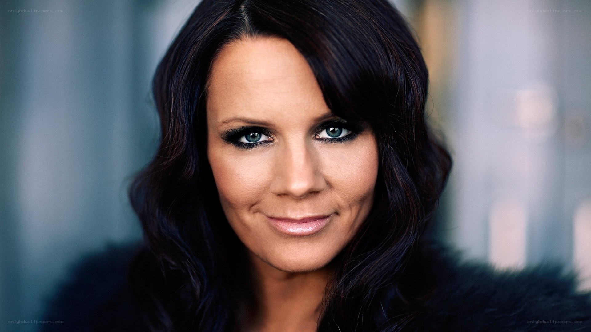 woman with dark hair and blue eyes