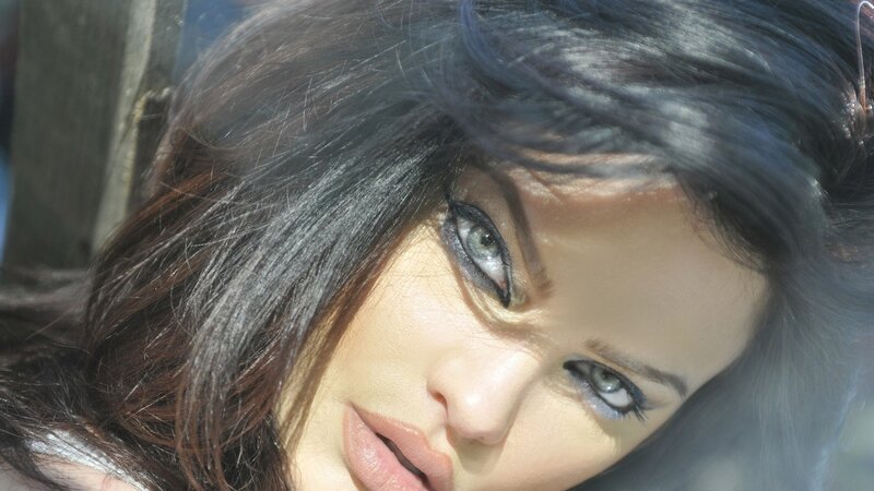 woman with dark hair and blue eyes