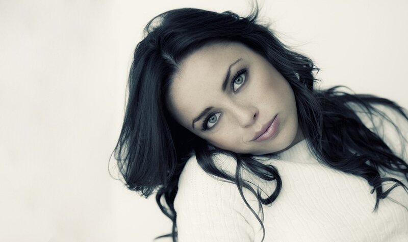 woman with dark hair and blue eyes