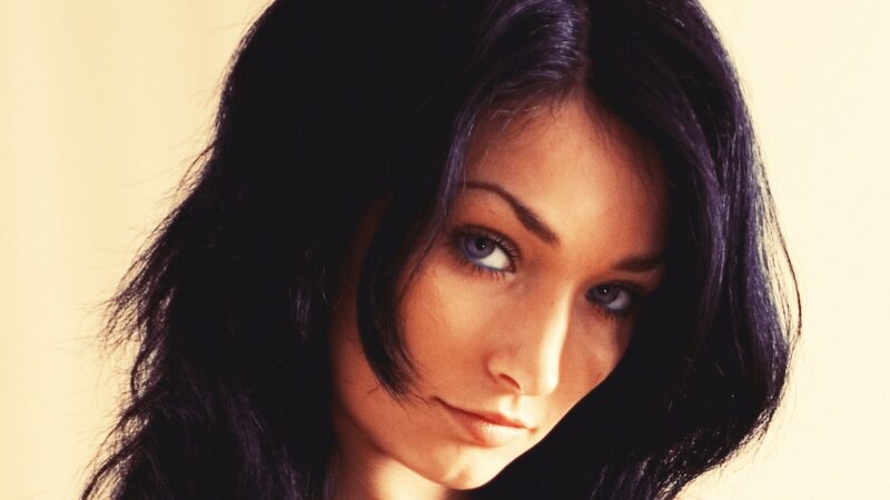 woman with dark hair and blue eyes