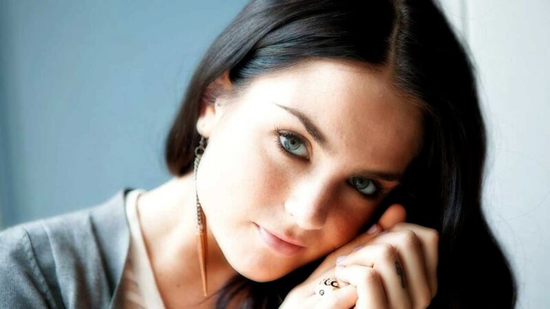 woman with dark hair and blue eyes
