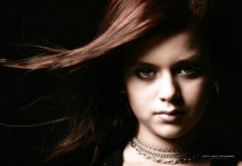 woman with dark hair and chains