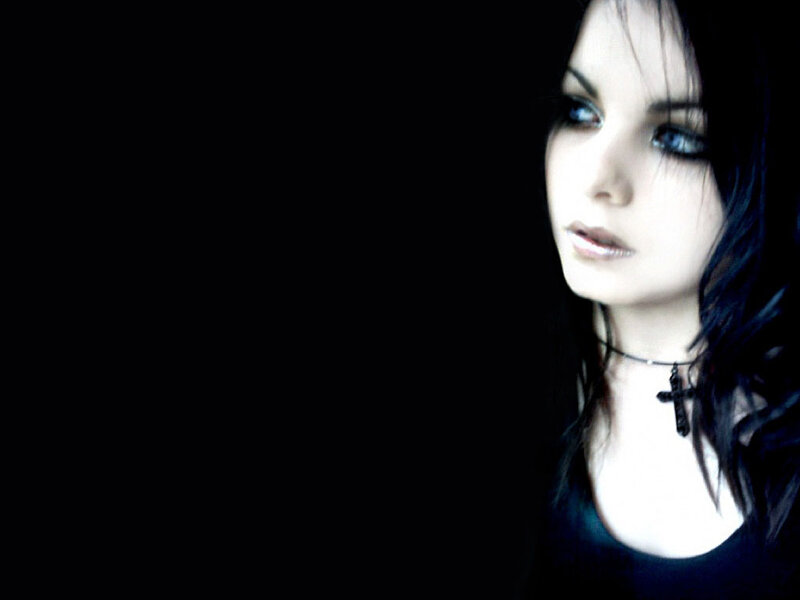 woman with dark hair and cross necklace
