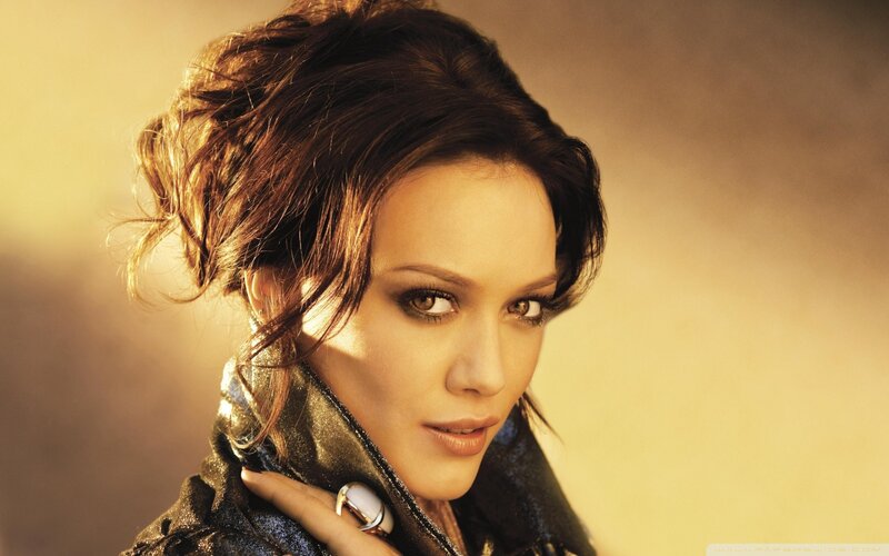 woman with dark hair and dramatic makeup