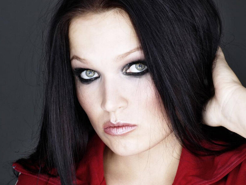 woman with dark hair and dramatic makeup