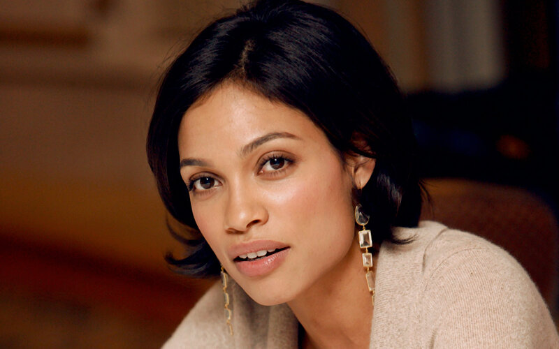 woman with dark hair and earrings