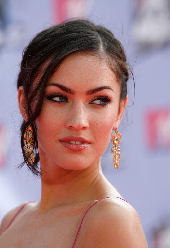 woman with dark hair and earrings