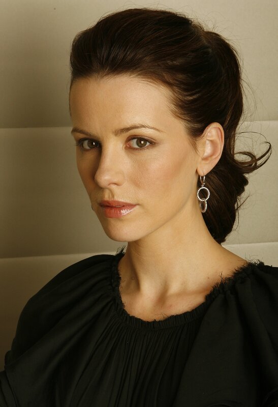 woman with dark hair and earrings