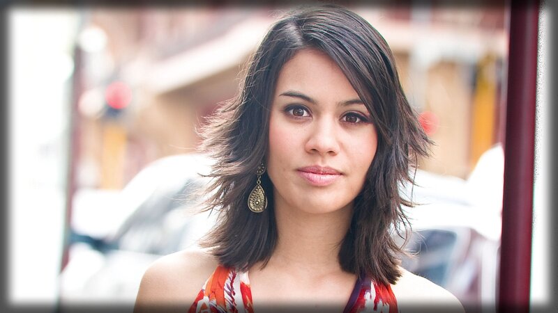 woman with dark hair and earrings