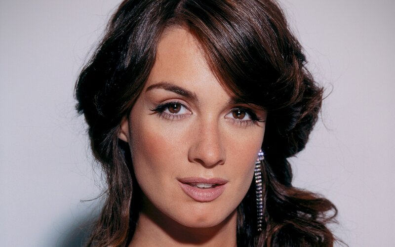 woman with dark hair and earrings