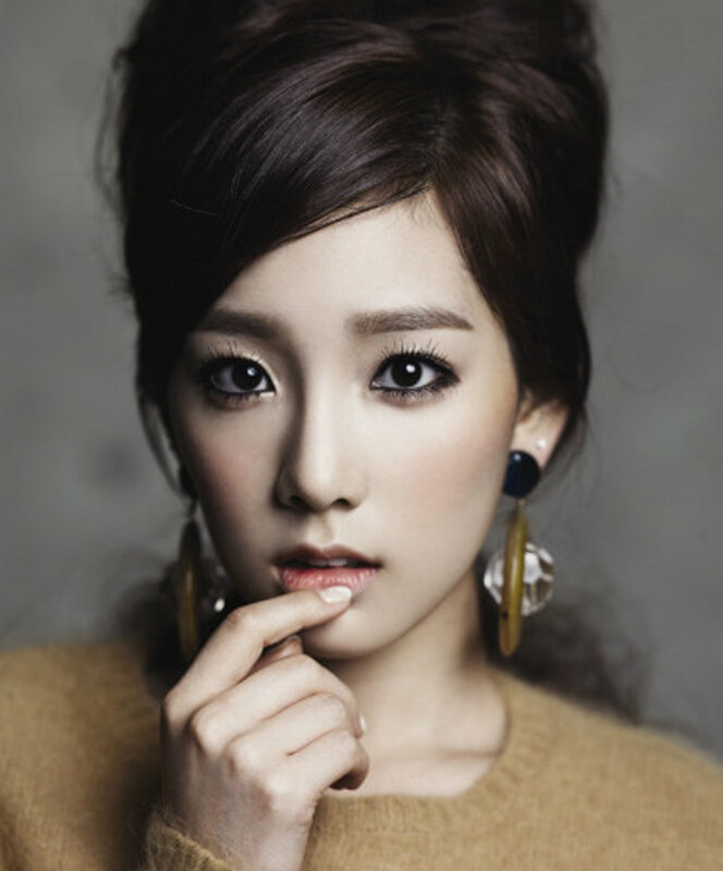 woman with dark hair and earrings