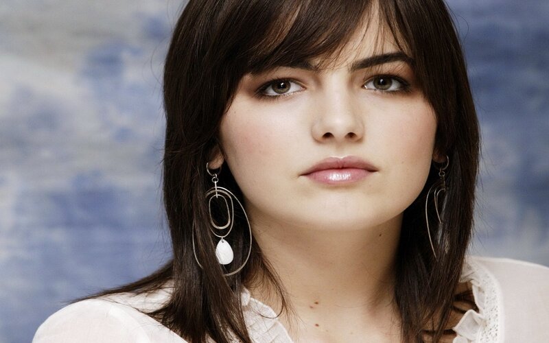 woman with dark hair and earrings