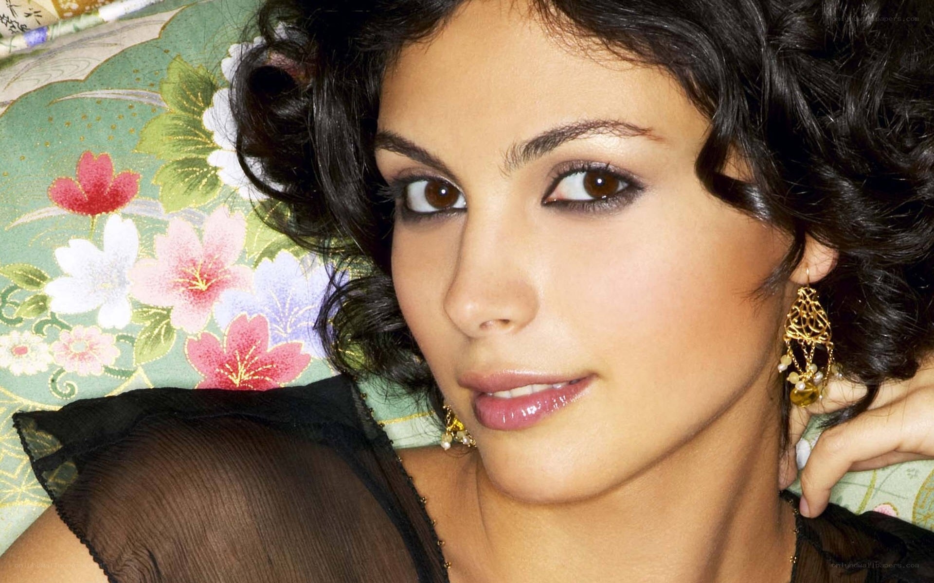 woman with dark hair and earrings