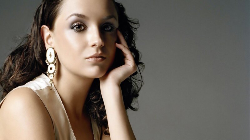 woman with dark hair and earrings