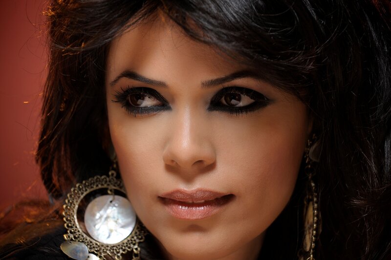 woman with dark hair and earrings