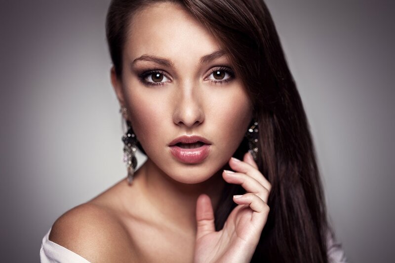 woman with dark hair and earrings