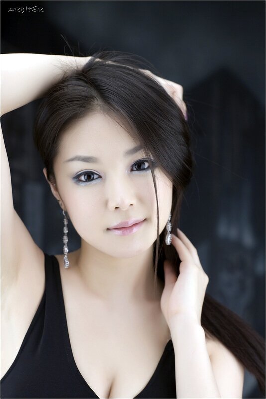 woman with dark hair and earrings