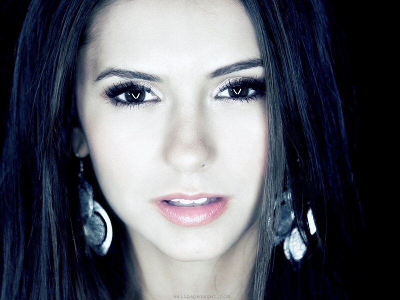 woman with dark hair and earrings