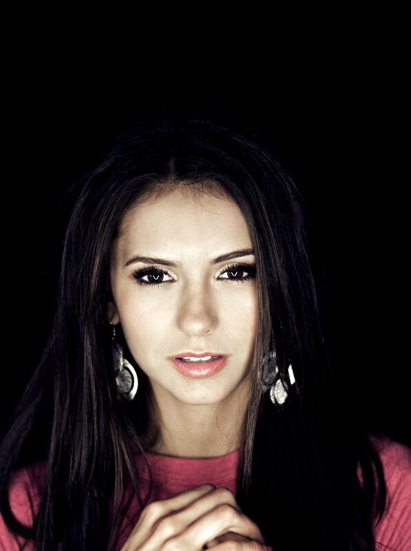 woman with dark hair and earrings