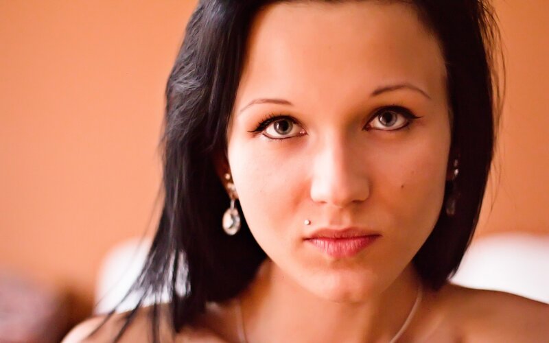woman with dark hair and earrings