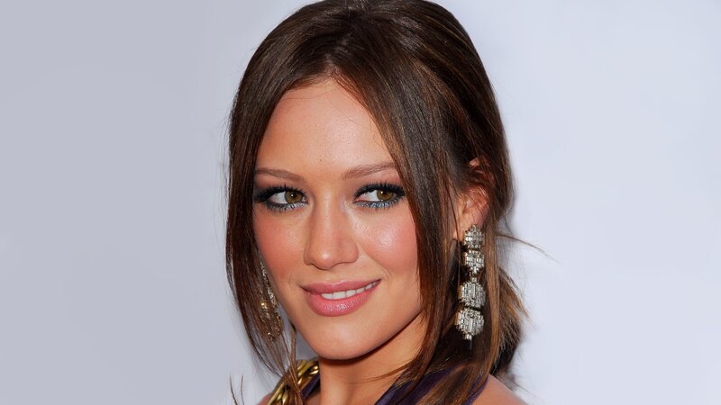 woman with dark hair and earrings