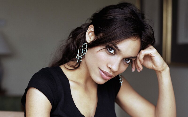 woman with dark hair and earrings