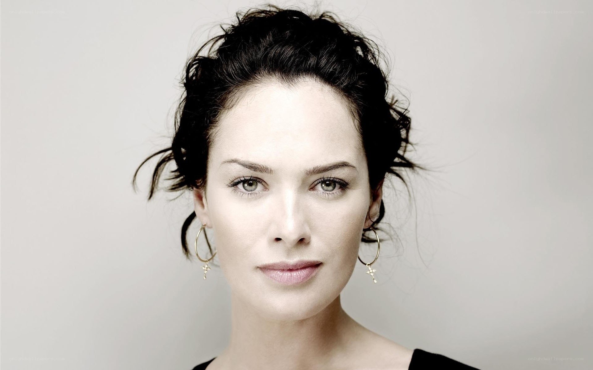 woman with dark hair and earrings