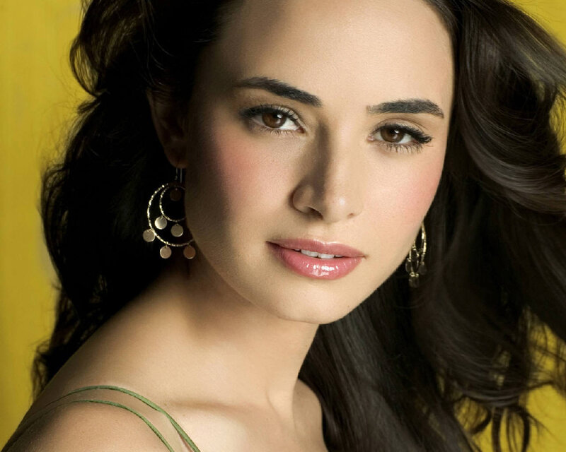 woman with dark hair and earrings