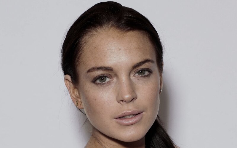 woman with dark hair and freckles