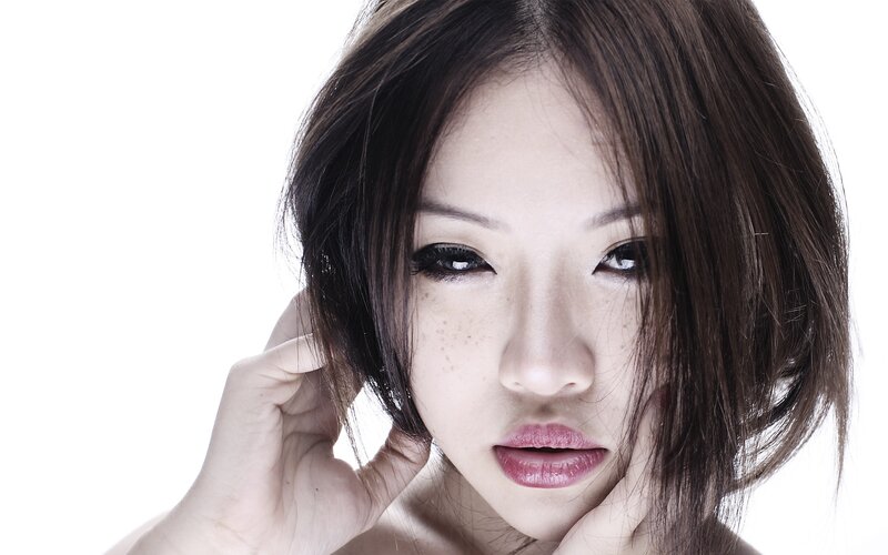 woman with dark hair and freckles
