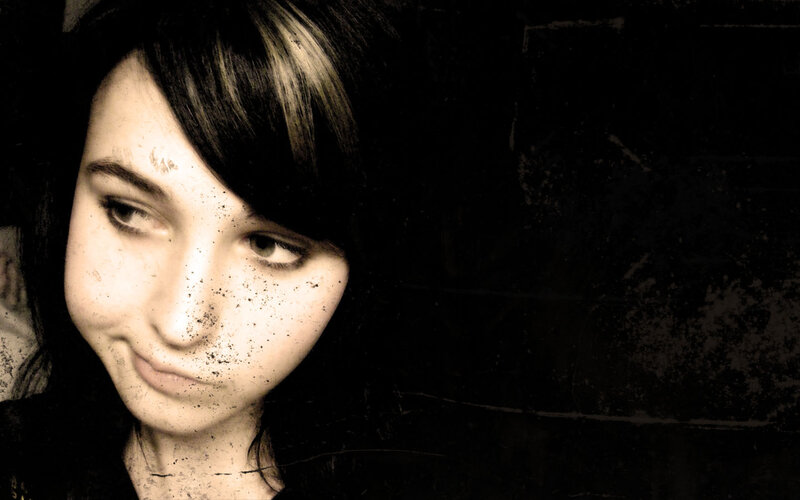 woman with dark hair and freckles