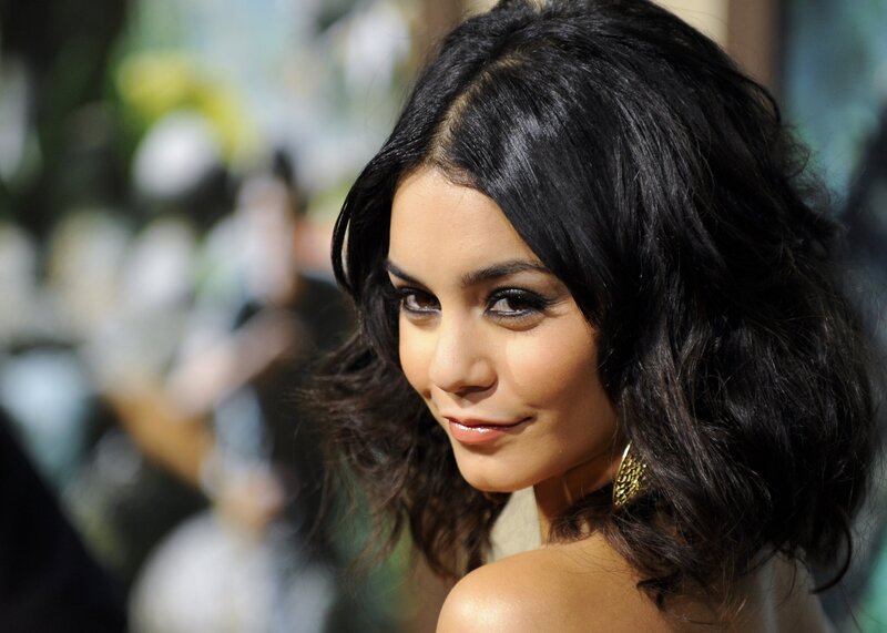 woman with dark hair and gold earring
