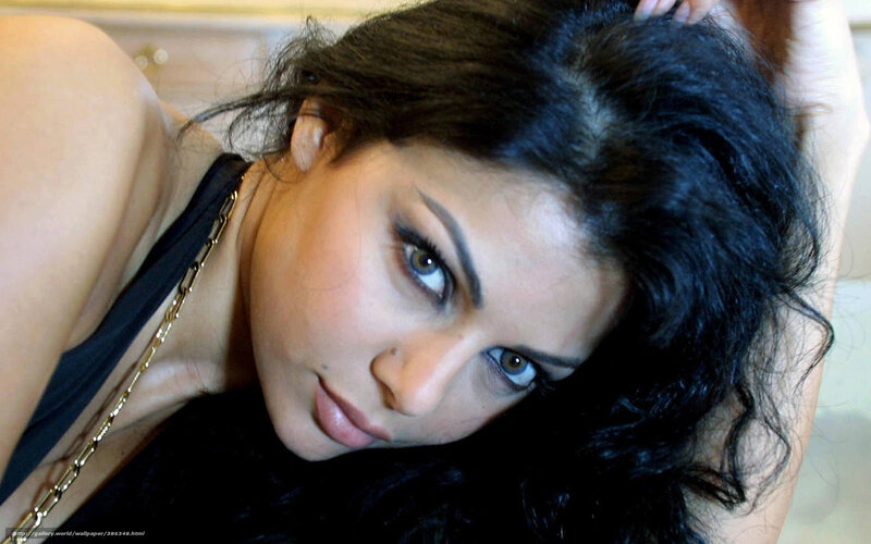 woman with dark hair and gold necklace