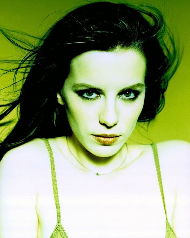 woman with dark hair and green background